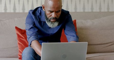 Focused entrepreneur working from home with laptop