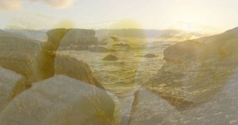 Rocky Coastline at Sunset with Golden Light Reflection