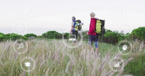 Mature couple hiking coastal trail with digital interface overlay