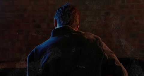 Moody Urban Silhouette of Man Against Brick Wall