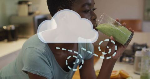 Woman Enjoying Green Smoothie for Healthy Start at Modern Kitchen