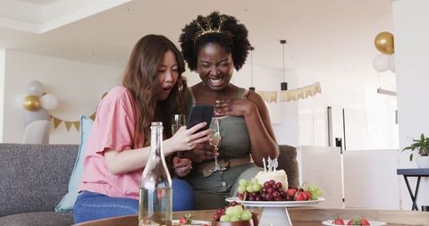 Joyful multicultural couple celebrating birthday party together