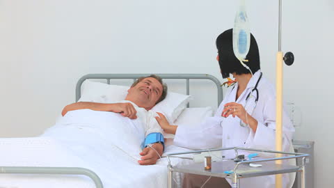 Smiling Patient Engaging with Nurse in Hospital Room