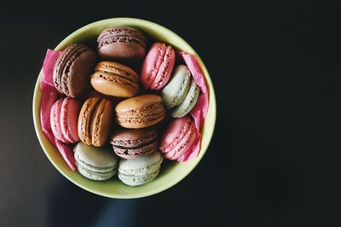 Top view colorful french macarons in bowl on dark background bakery branding food blogs