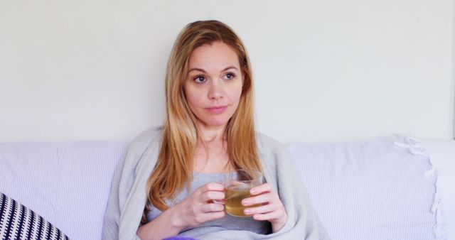 Woman Relaxing on Couch with Cup of Tea - Download Free Stock Images Pikwizard.com