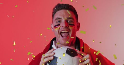 Joyful German Football Fan Celebrating Victory with Confetti