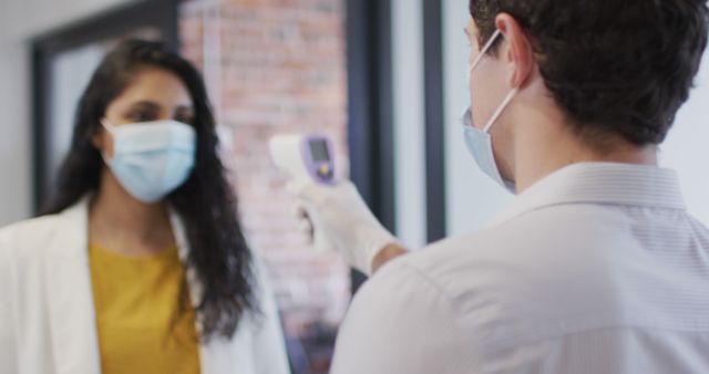 Healthcare Worker Checking Woman's Temperature during Pandemic - Download Free Stock Images Pikwizard.com