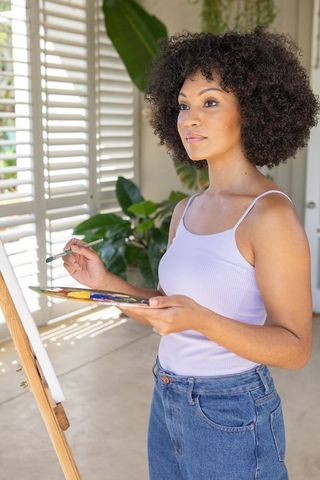 Creative Young Woman Engaged in Painting at Home Studio