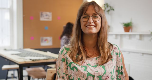 Smiling Woman with Glasses in Creative Workspace - Download Free Stock Images Pikwizard.com