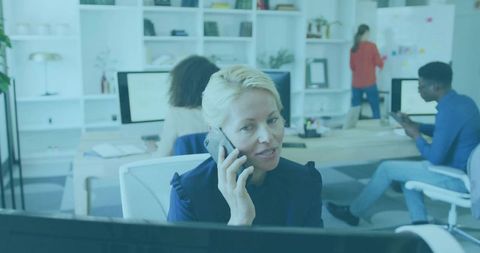 Blonde Businesswoman Communicating on Phone in Modern Office Environment