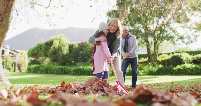 Family Enjoying Autumn Day by Raking Leaves in Backyard Garden - Download Free Stock Images Pikwizard.com