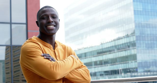 Confident Young Man Smiling Outdoors Near Modern Buildings - Download Free Stock Images Pikwizard.com