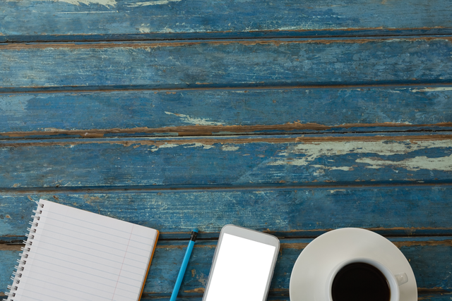 Transparent Smartphone Notebook Coffee Cup on Rustic Blue Wooden Background - Download Free Stock Videos Pikwizard.com