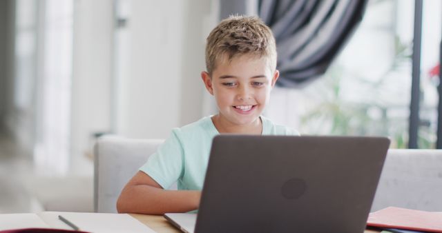 Boy Smiling While Using Laptop at Home - Download Free Stock Images Pikwizard.com