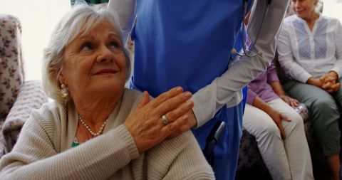 Senior woman with female doctor in nursing home
