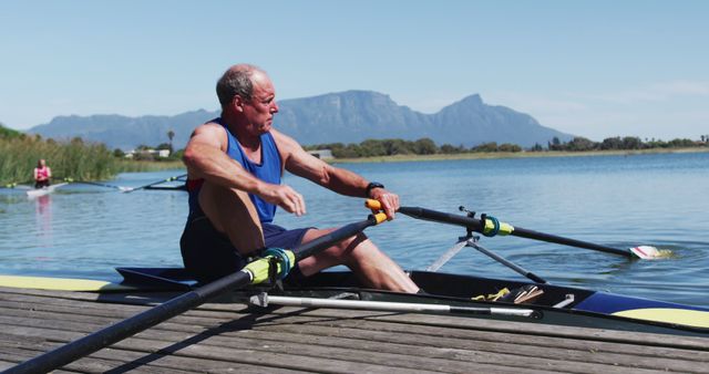 Senior Man Preparing for Rowing in Mountainous Lake Area - Download Free Stock Images Pikwizard.com