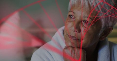 Senior Woman Gently Gazing with Red Geometric Projections