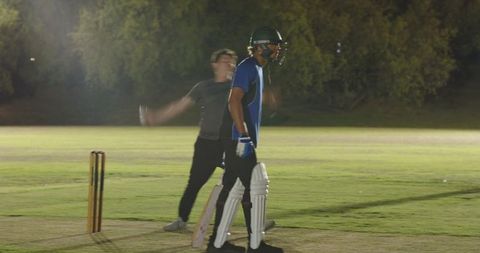 Night cricket appeal showing bowler celebrating while batsman walking off after dismissal