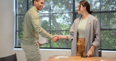 Successful business meeting: diverse colleagues shaking hands