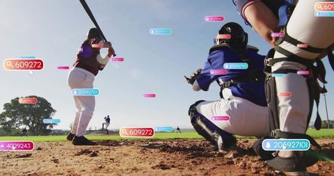 Female batter swinging at home plate with catcher crouching and AR analytics overlay