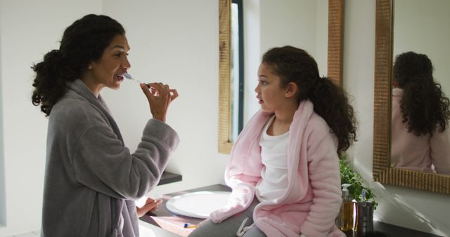 Mother Brushing Teeth with Daughter in Bathroom - Download Free Stock Images Pikwizard.com