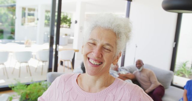 Portrait of happy senior caucasian woman with other seniors at retirement home. healthy, active retirement and body inclusivity.