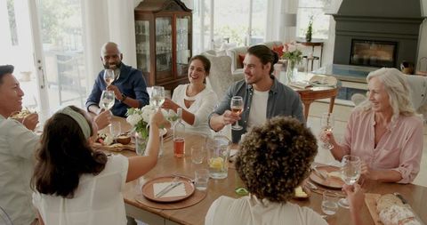 Joyful Gathering of Friends and Family Around Dining Table