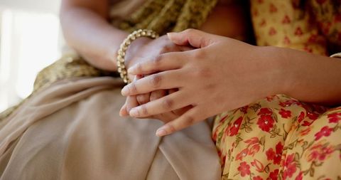 Mother and Daughter Holding Hands Wearing Traditional Saris