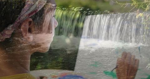Creative artist painting with inspiring waterfall reflection