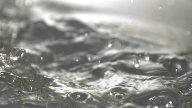 Cob of corn in dynamic motion as it splashes into water, creating captivating ripples and droplets. This image can symbolize freshness and energy, often used in food-related concepts, agricultural promotions, or dynamic visuals to depict motion and fluidity.