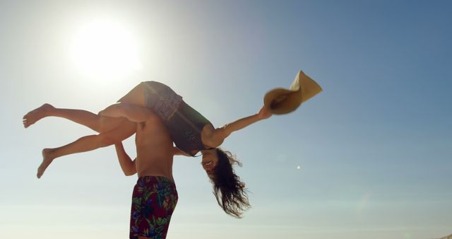 Couple Enjoying Summer on Beach with Playful Lift - Download Free Stock Images Pikwizard.com