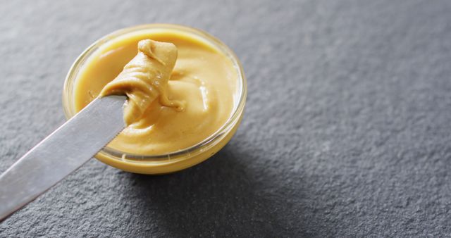 Close Up of Smooth Peanut Butter in Glass Bowl with Butter Knife - Download Free Stock Images Pikwizard.com