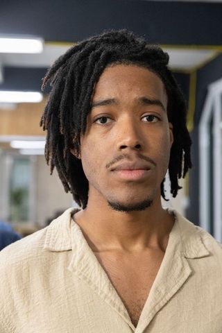 African american young professional portrait looking at camera in modern coworking space
