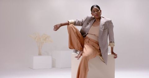 Indian Woman Posing in Minimalist Studio with Business-Casual Outfit