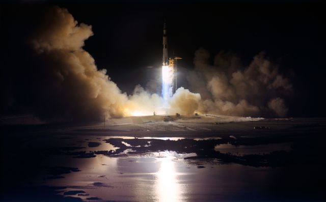 This image showcases the historic nighttime launch of Apollo 17 on December 7, 1972, from Kennedy Space Center. The fiery blast of the Saturn V rocket illuminates the night, reflecting in the surrounding waters. Great for educational materials, historical documentaries, and articles celebrating space exploration and NASA's milestones.