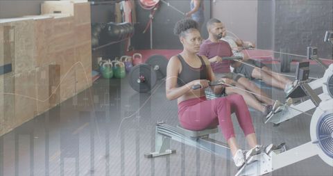 Woman and Man Rowing in Gym with Digital Overlay - Download Free Stock Images Pikwizard.com