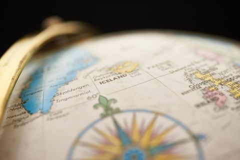 Vintage globe focusing on iceland and north atlantic with compass rose detail
