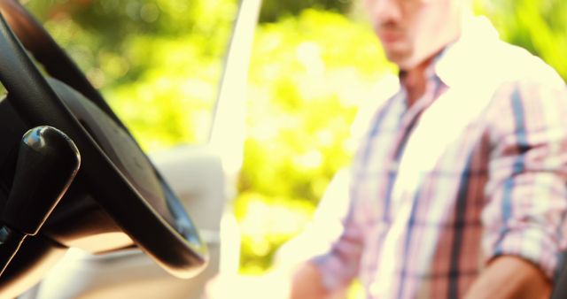 Man wearing plaid shirt entering parked car on sunny day - Download Free Stock Images Pikwizard.com