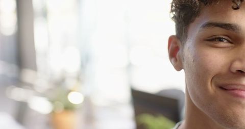 Man Smiling in Contemporary Café Interior with Natural Light