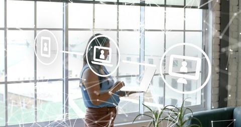 Businesswoman Holding Laptop Connecting Digital Network in Modern Office