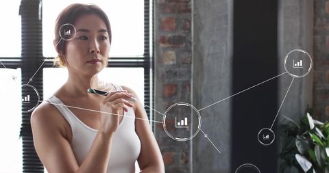 Businesswoman Analyzing Data with Virtual Interface in Office