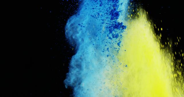 Blue and yellow powder exploding against a black background, creating a vibrant and dynamic visual effect. Ideal for use in artistic projects, festival promotions, ad campaigns, and as abstract backgrounds for websites or presentations.
