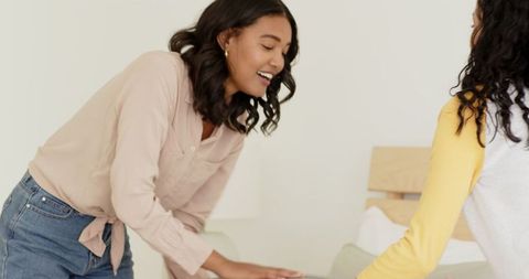 Mother and daughter packing for travel with smiles