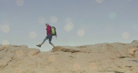 Adventurous Woman Hiking on Rugged Mountain Terrain - Download Free Stock Images Pikwizard.com