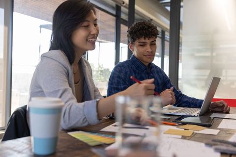 Diverse Coworkers in Creative Studio Collaborating on Design Project