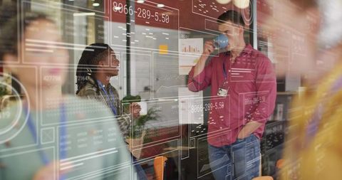 Two Professionals Collaborating with Digital Data Overlay in Modern Office