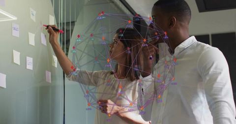 Collaborating on glass wall with holographic data network and sticky-note planning