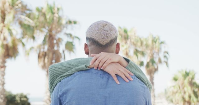 Couple embracing outdoors with palm trees in background - Download Free Stock Images Pikwizard.com