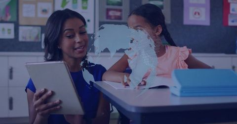 Teacher teaching with tablet while student exploring digital globe and studying geography