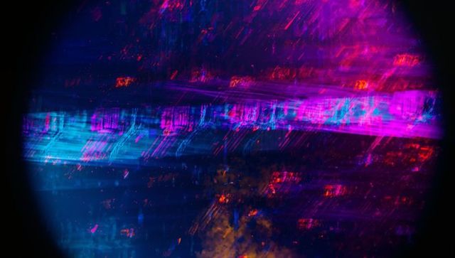 Vibrant Neon Glitch with Magenta, Cyan, and Orange Over Dark Background